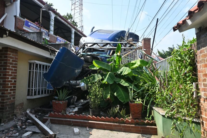Head loses brakes, causes multiple accidents and ends up embedded in two homes